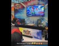 Guy wearing red bodysuit winds video game 