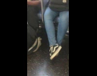 Man blue shirt eats whole mango with skin on subway train