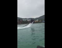 Guy on board flies spins lake mountain 