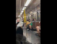 Man sing inside subway train with microphone