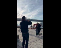 Proposal at park cyclist balance tire on head