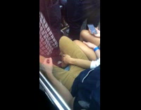 Girl slaps back and forth inside guys thighs, guy does the same on subway train