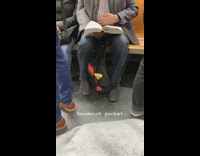 Man has loaf of bread inside backpack side pocket on subway train