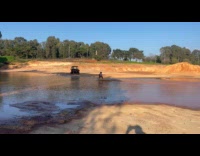 Man skim board on the muddy water