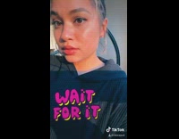 Girl freeze frame whispers in own ear 