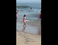 Woman drinks in large glass at beach