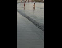 Woman in bikini poses while a kid takes her picture