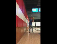 Guy throws chucks green bowling ball pins 