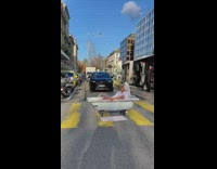 Woman take bath tub on street traffic