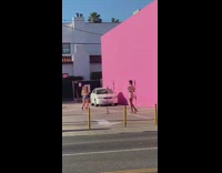 Two women in different photoshoot at the pink wall