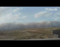 White shirt guy watches sandstorm get closer 