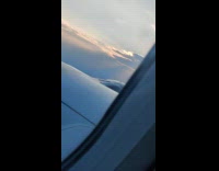 Wind vortices on plane wing window sunset