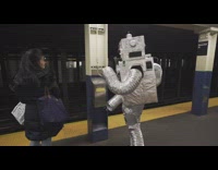 Subway passengers plays Super Mario Bros game on robot body 
