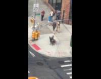 Collab WINY - Man wheels himself on office chair on sidewalk