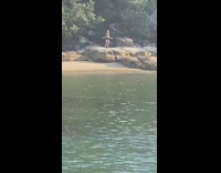 Girl black bikini dance on rock beach