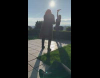 Blonde girl poses with two wine bottles in the sun nice view