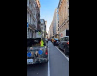 Parked truck with goat and hay street