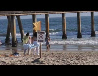 Collab IITW - People dance beach with sheets no swimming sign