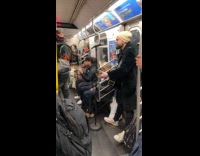 Man plays guitar and sing on subway