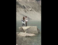 Couple white top timer shoot at lake