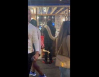 Multiple people on street with pet snake