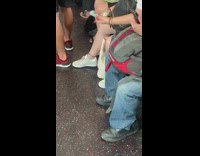 Woman rubs deodorant all over her body on the train