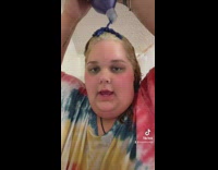 Girl dyes hair blue with purple conditioner