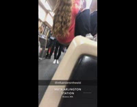 Two girls hang off subway handrail 