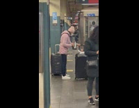 Lady Holds Electric Kettle at Subway Station