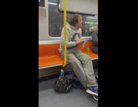 Man hold and kiss pet rat subway