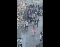 Woman pink jacket tiktok dance balcony building