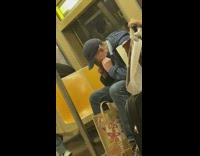 man in blue hat flossing teeth