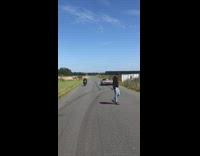 Car and motorcycle race each other 