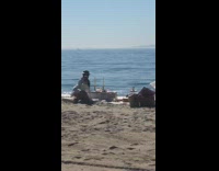 Woman hat table two long candles beach