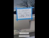 Brown car has paper sign on it