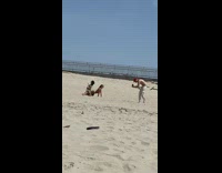 Two women in bikini dramatic dance at the beach