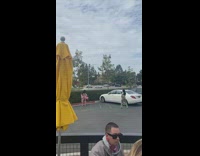 Pink dress girl poses restaurant parking lot