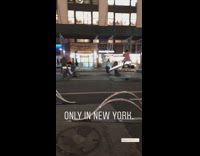 Pedestrians ride light up seesaws on the street in New york