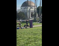 Man sing dance shake hips with bells park