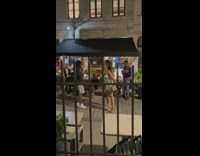 Two girls cover camera walk beside customers