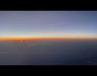 Sunrise seen from the airplane window in the sky