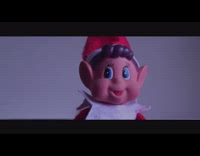 Elf doll toy types on black laptop 