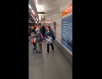 People in caution cone costume rides train