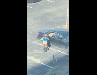 Blue shirt girl dances parking lot earphones 