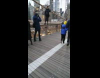 Woman stands on top of bridge barrier for a photo