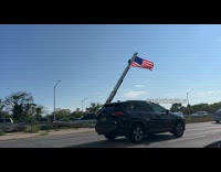 Fire truck use ladder as flag pole