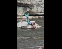 Woman mermaid costume river rocks photo shoot