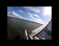 Man windsurfing falls from board 