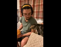 Cat steal string snack from guy mouth
