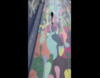 Girl dancing in art painted area by herself recording